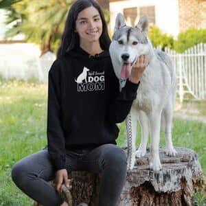 Woman wearing Black Well Trained Dog Mom Hoodie